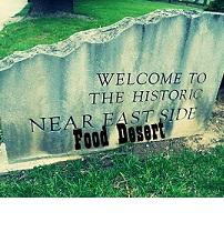 Sign that says Welcome to the Historic Near East Side and the words superimposed below Food Desert