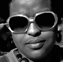 Black woman's face close up, wearing large sunglasses
