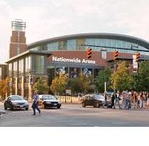 Big brick building with rounded top and lots of people out front and words on it Nationwide Arena