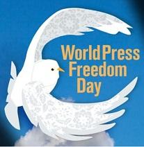 Bright blue background and drawing of white dove with wings encircling the words World Press Freedom Day