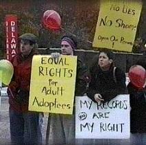 People outside holding protest signs saying Equal Rights for Adult Adoptees