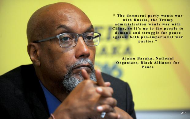Bald black man with hands folded in front of chin, wearing glasses and with a gray goatee against yellow background and some words