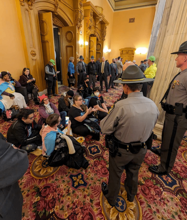 Cops surrounding people at a sit-in