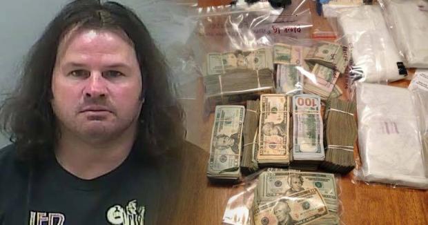 Mug shot of disheveled white guy with long hair next to money and drugs