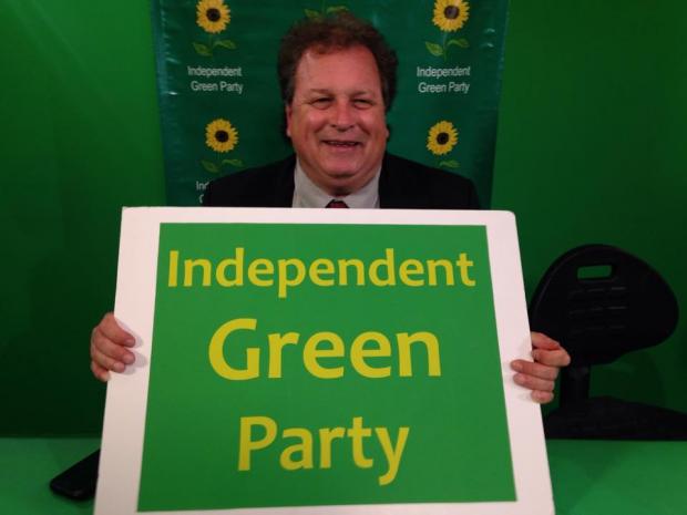 Man holding sign that says Independent Green Party
