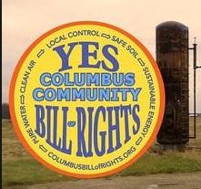 Round yellow logo with words Yes Columbus Community Bill of Rights and a fracking well in background