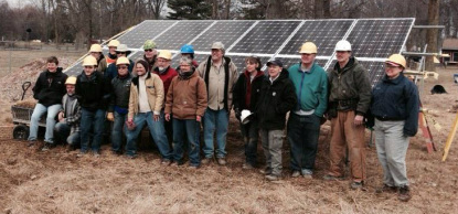 People involved in Clintonville Energy Co-op posing by solar panels