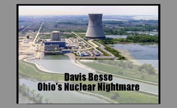 A large conical shaped cement building with other little buildings around and river of water leading to it with the words Davis Besse Ohi's Nuclear Nightmare