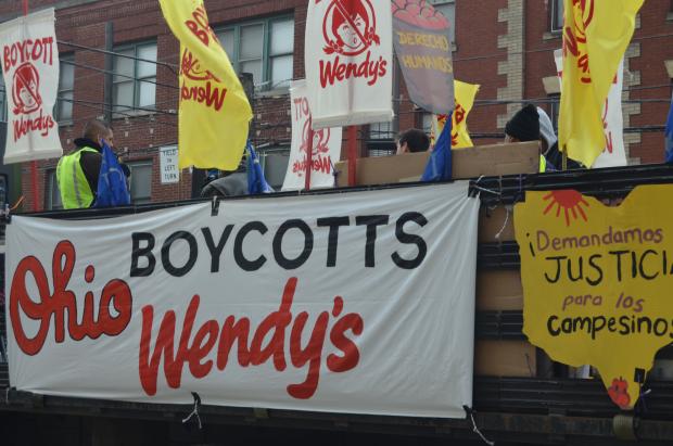 Big truck with signs to Boycott Wendy's at start of march down High Street