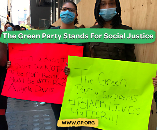 People holding signs and saying Green Party stands for social justice