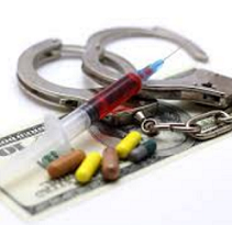 Handcuffs, a syringe, pills and a 100 dollar bill