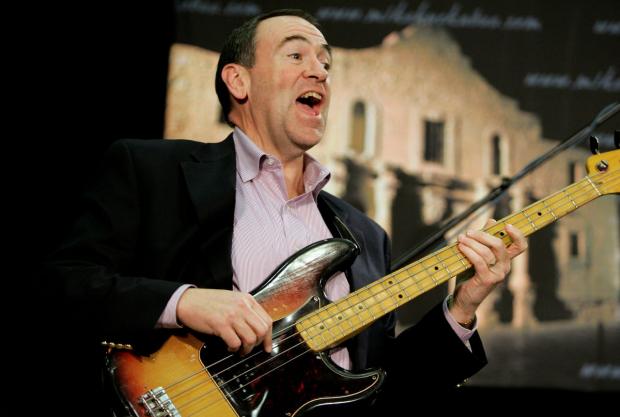 Mike Huckabee playing the bass guitar
