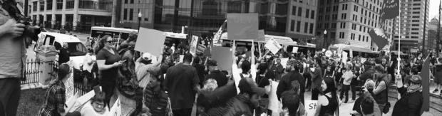 Black and white photo of people holding signs and protesting