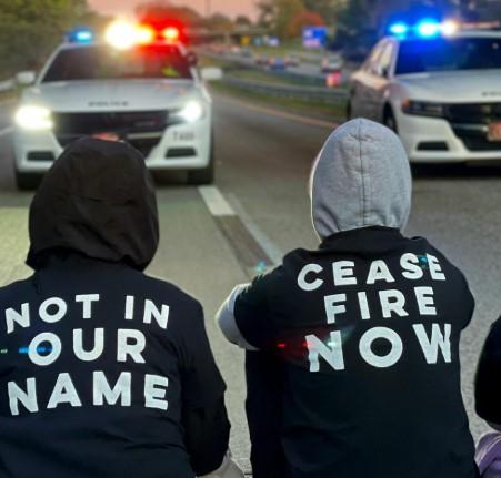 People protesting blocking police cars