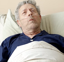 Old man with oxygen in his nose, in a bed