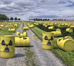 Barrels with radioactive symbols on the ground