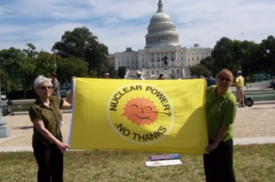 People holding sign saying Nuclear Power No Thanks in front of Congress 