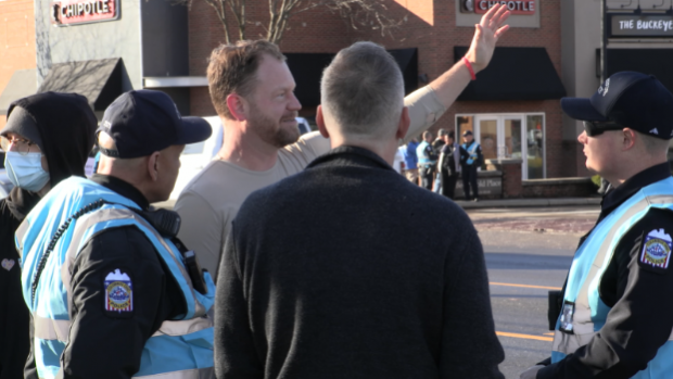 Men talking with police on the street
