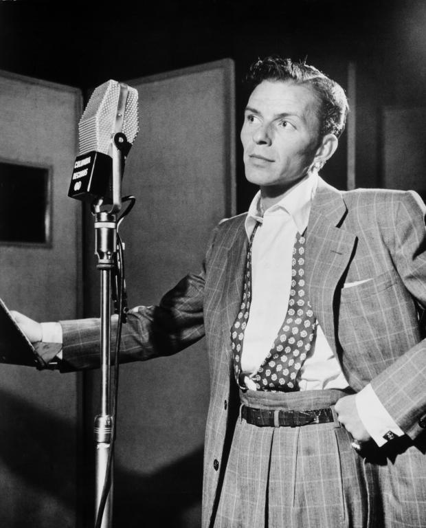 Black and white photo of young Frank Sinatra at the mic