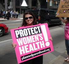 Woman holding sign that says Protect Women's Health