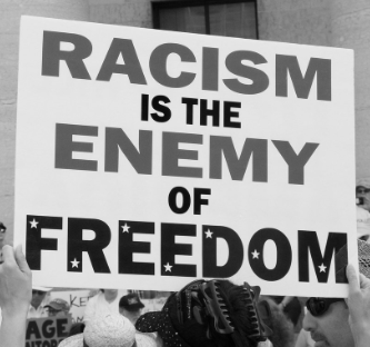 Sign reading Racism is the Enemy of Freedom