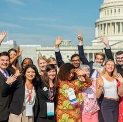 People posing outside capitol building