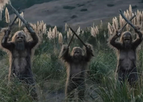 Three Sasquatches holding sticks in the air