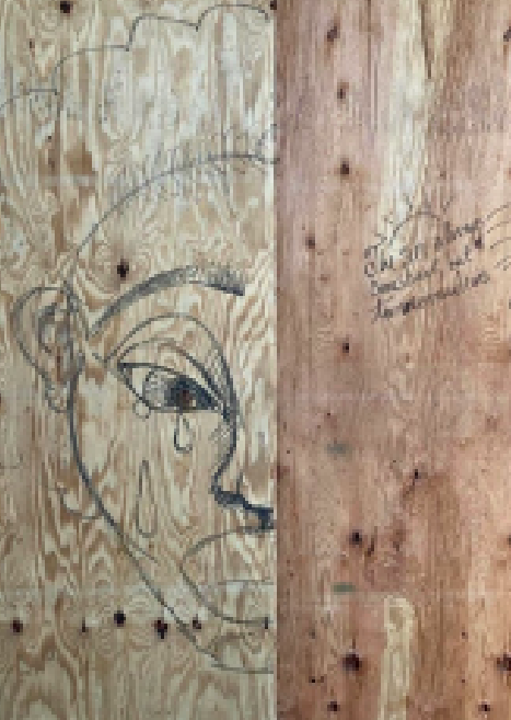 Face drawn crying on a piece of wood
