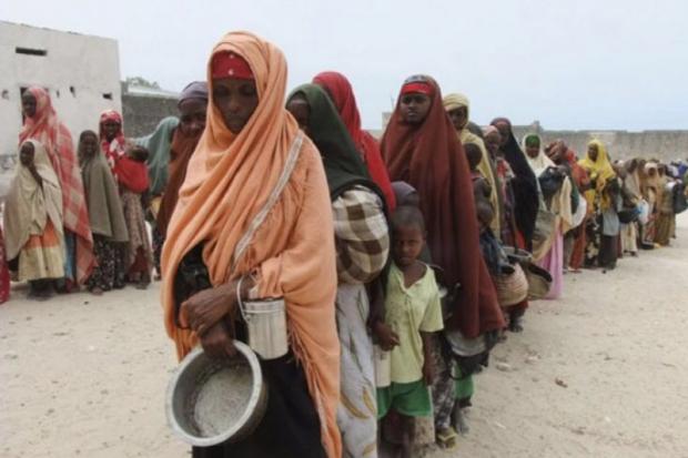 Somalian women in Somalia wearing headresses standing in line waiting for food