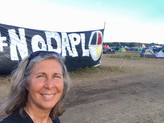 Heidi Detty in front of No DAPL banner