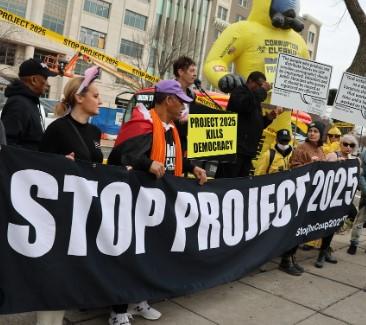 Protestors with Stop Project 2025 banner