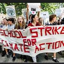 Young people marching outside with a banner reading School Strike for Climate Action
