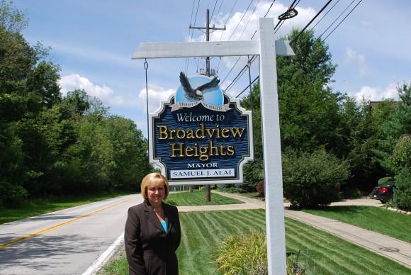 Blonde woman next to the Broadview Hts sign