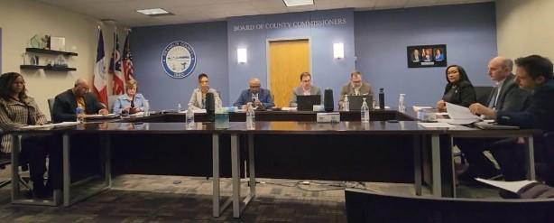 The hearing panel seated at a long table