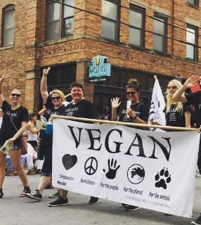 People marching with Vegan banner