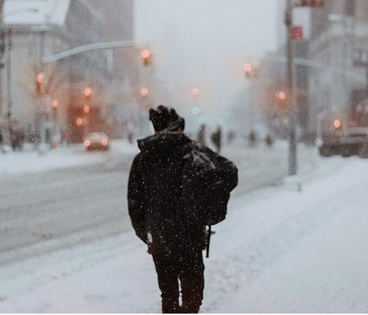 Back of man outside on a snowy street