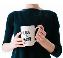 Woman's torso with hands holding mug that says Like a Boss
