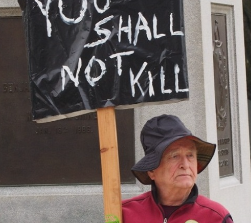 Protester with sign saying You Shall Not Kill