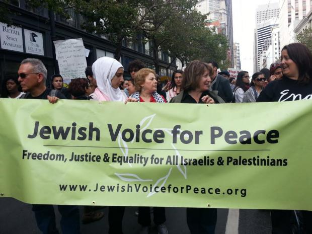 People marching with Jewish Voice for Peace banner