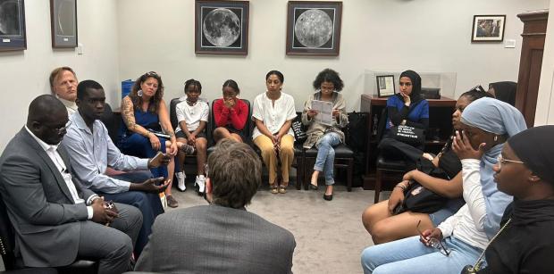 People sitting in a circle at a meeting