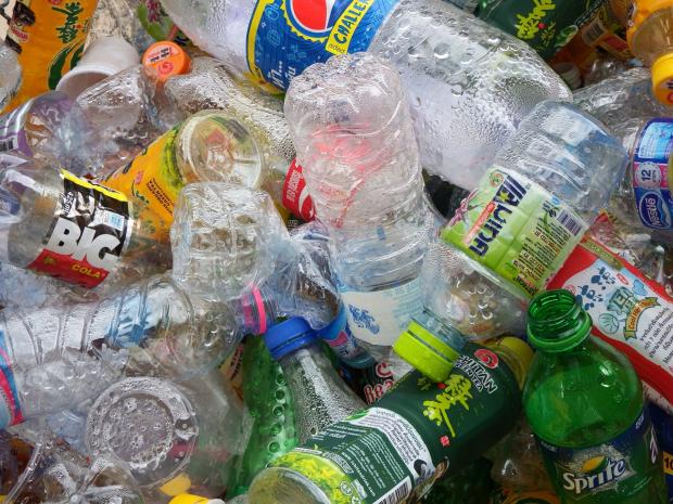 Colorful photo of empty plastic bottles all lying on top of each other in a heap
