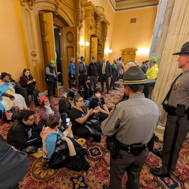 Cops surrounding people at a sit-in