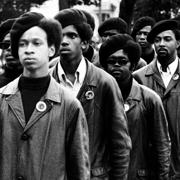 Black Panthers in berets in black and white photo