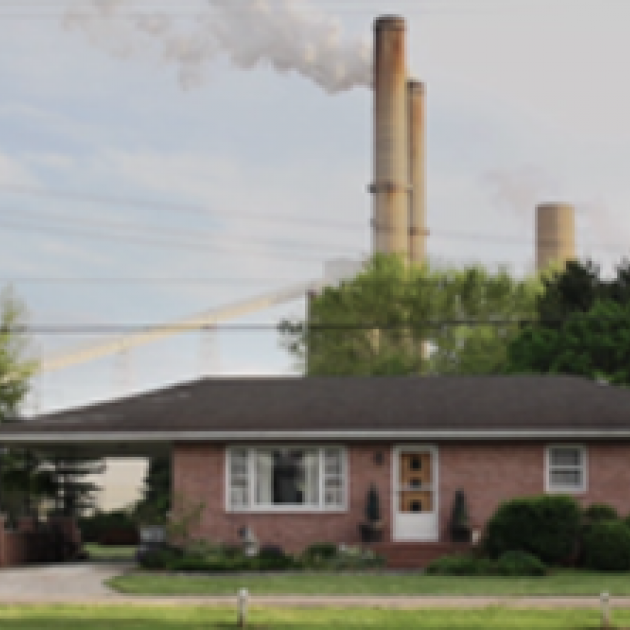 House with coal plant in background