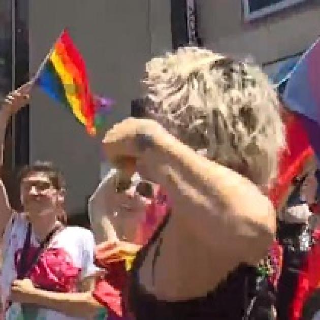People dancing and a rainbow flag flying