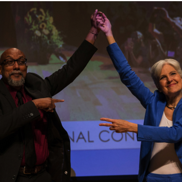 Ajamu and Jill holding up their hands in victory