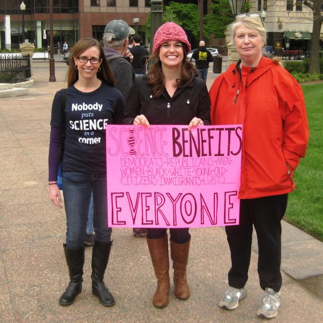 Three women holding sign that says Science Benefits Everyone