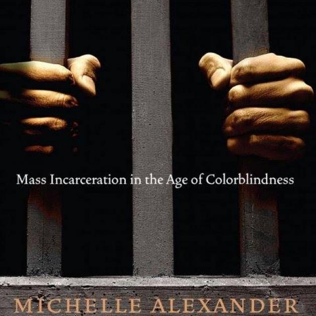 Cover of New Jim Crow book with hands on bars like in a prison