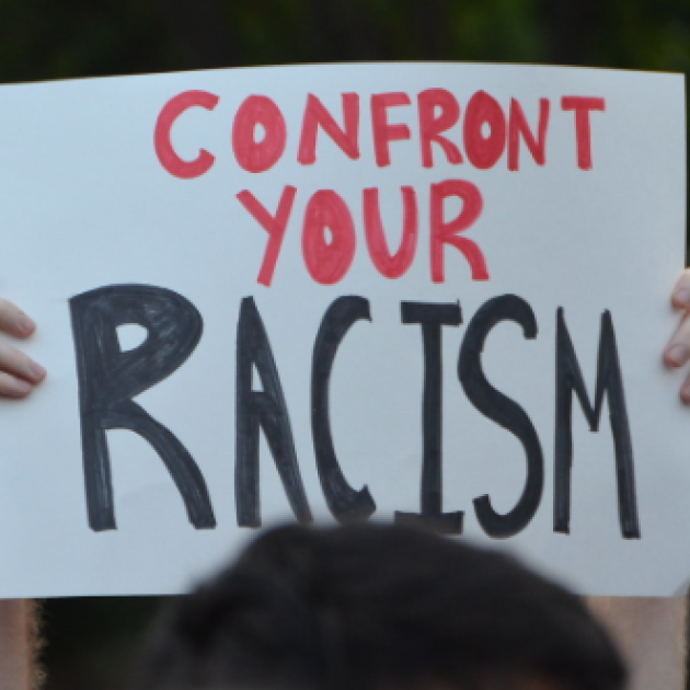 Sign saying confront your racism