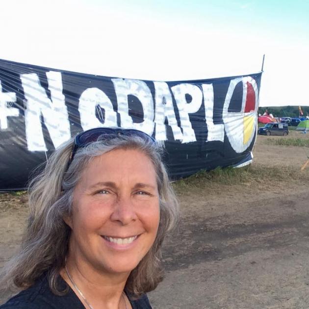 Heidi Detty in front of No DAPL banner